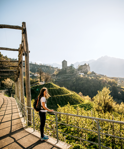 A woman is enjoying the view of Tirolo